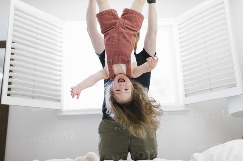Father swinging daughter