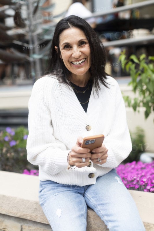 Portrait of smiling woman using phone