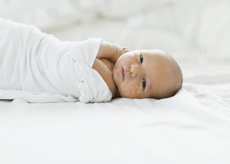 Portrait of swaddled newborn boy