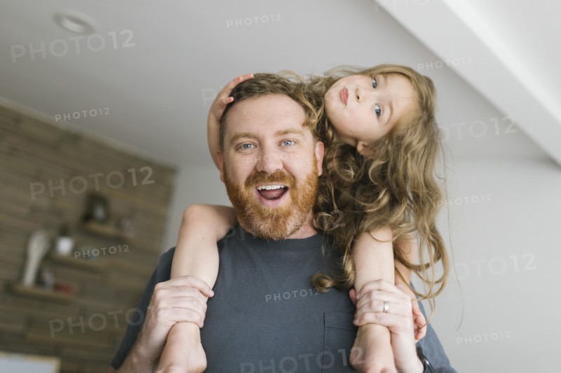 Father carrying daughter