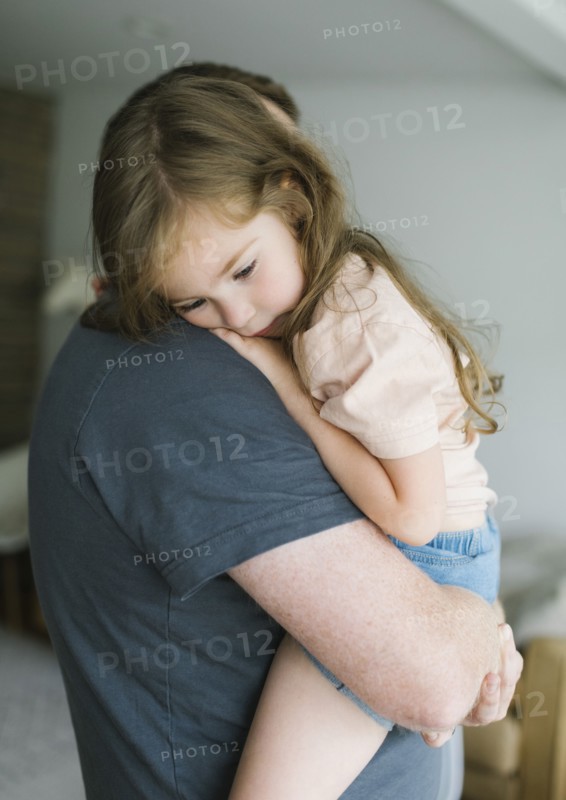 Father holding daughter