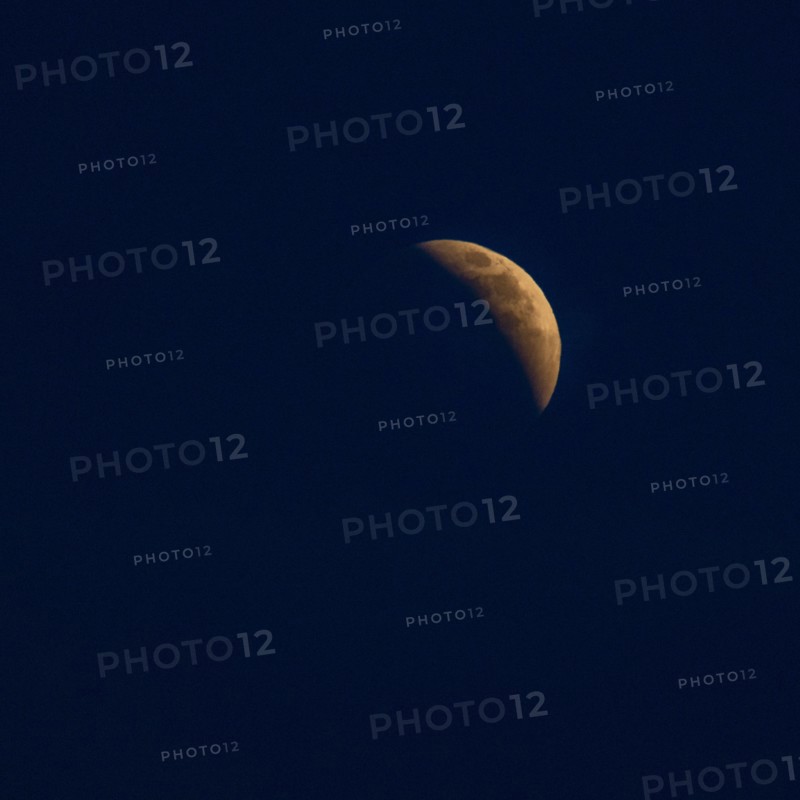 Moon rising in dark sky