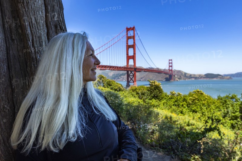 Senior woman sitting in shade with view of Golden Gate Bridge