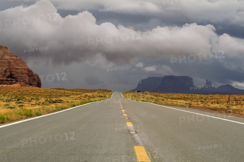 Storm clouds above desert road