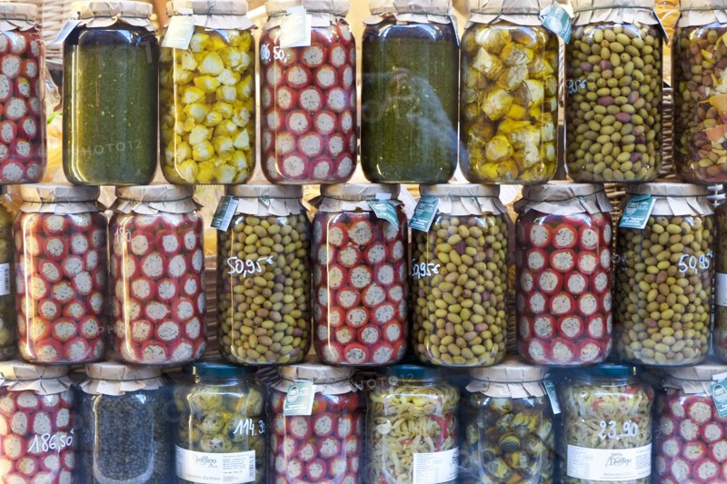 Olives stuffed peppers and marinated vegetables on display