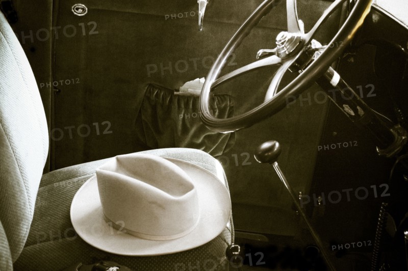 Fedora in vintage car