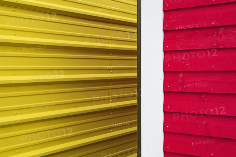 Close-up of yellow and red building walls