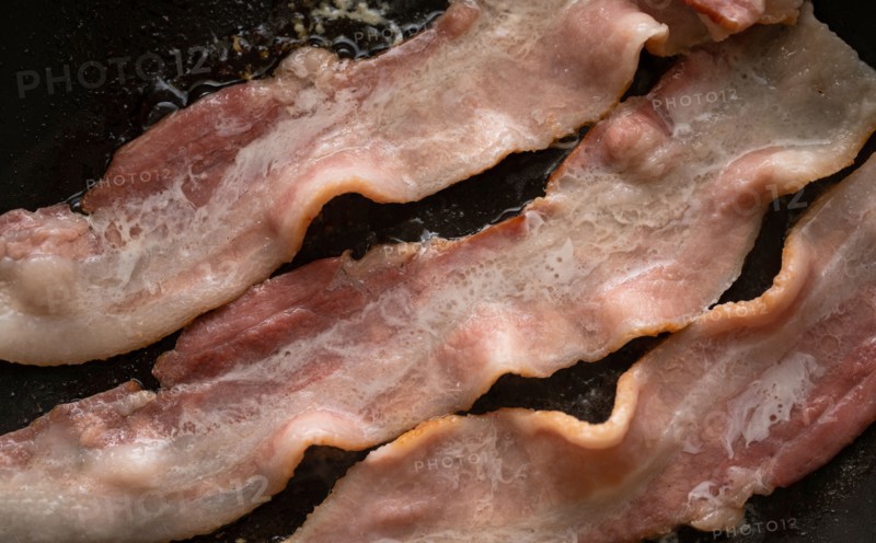 Close-up of bacon slices on frying pan