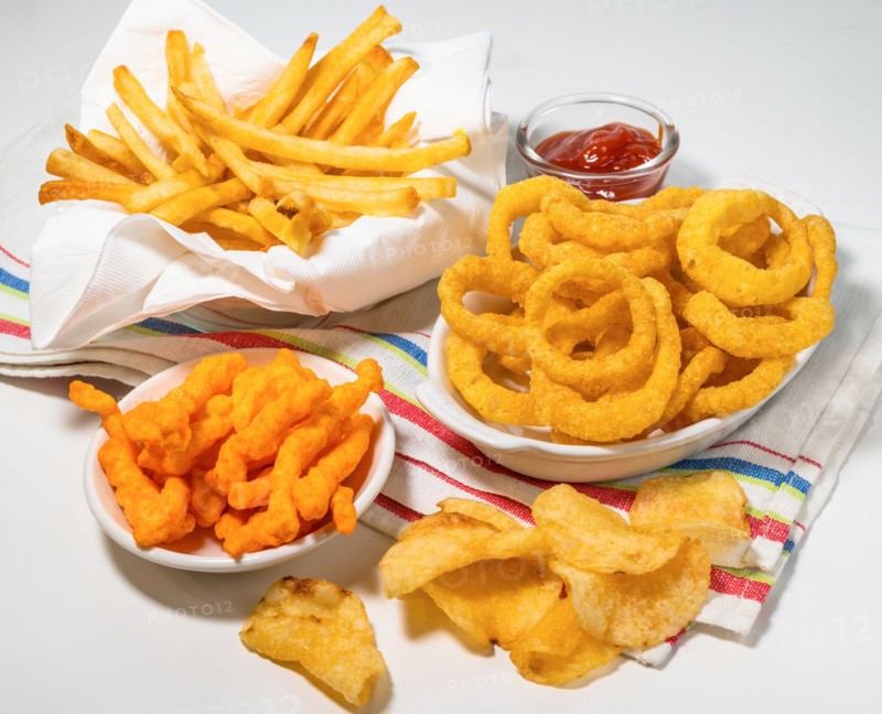 Assorted fattening processed foods on tablecloth