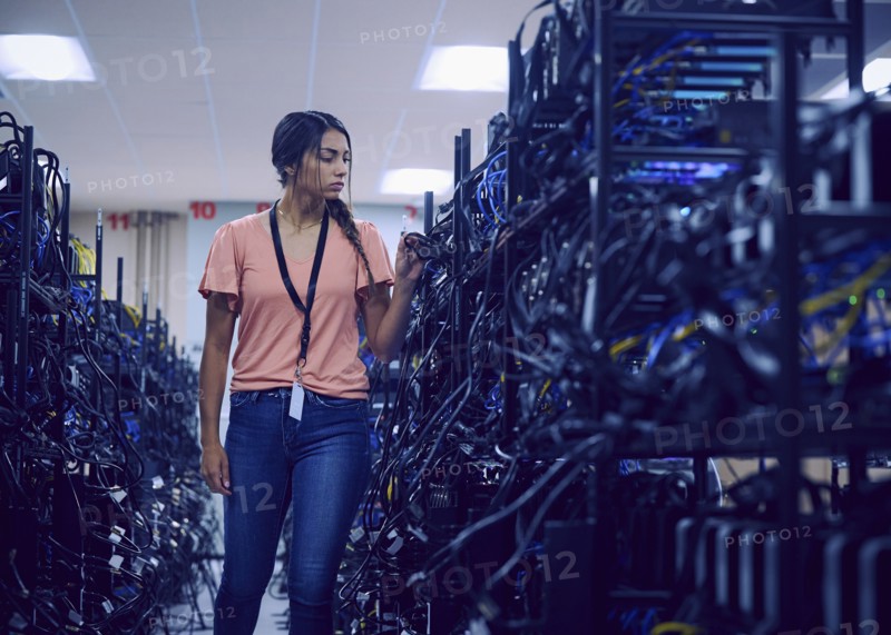 Female technician working in server room