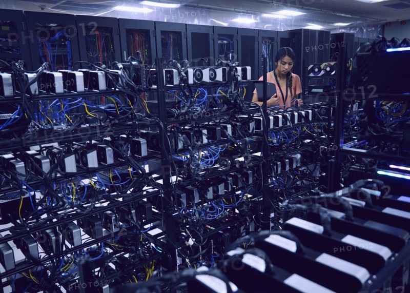 Female technician working in server room