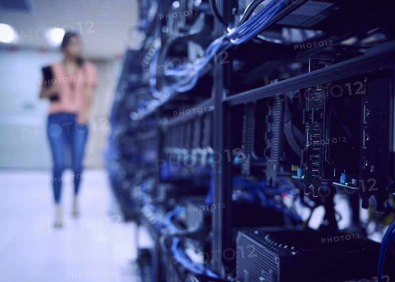 Female technician working in server room