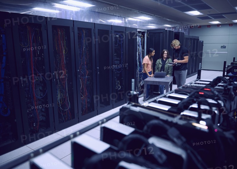 Team of technicians working in server room