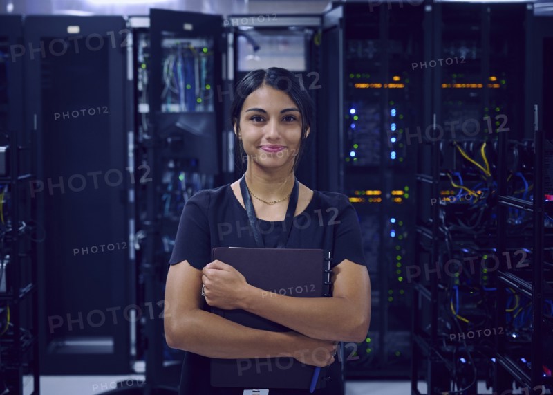 Portrait of smiling female technician in server room
