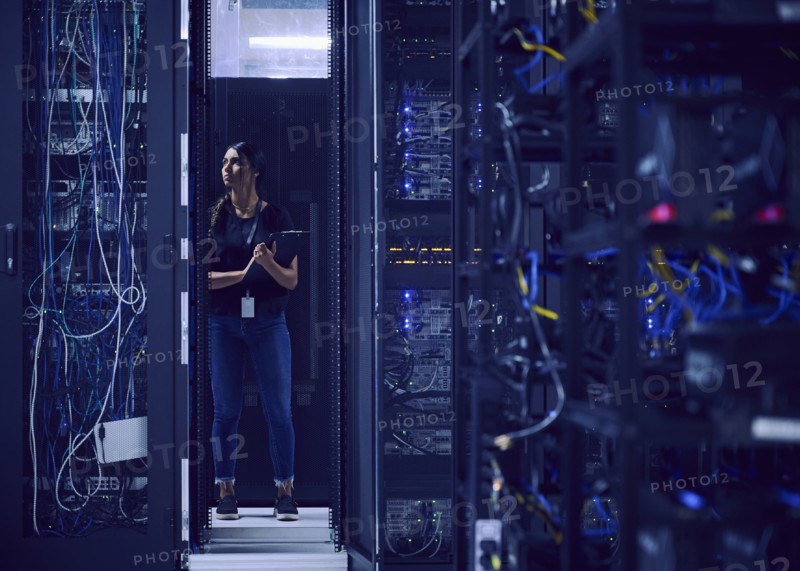 Female technician working in server room
