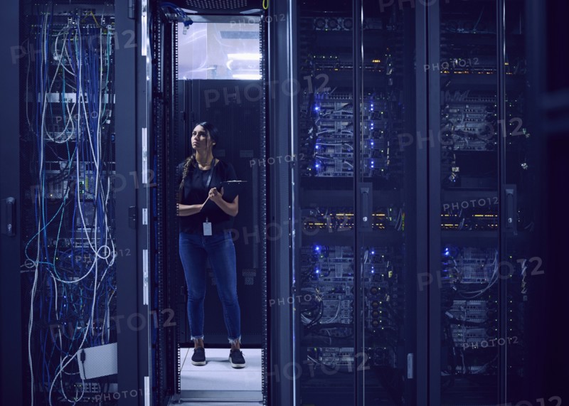 Female technician working in server room