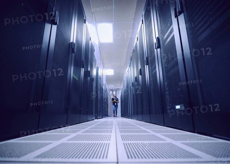Female technician working in server room