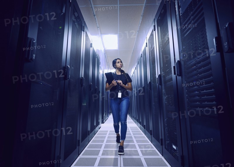 Female technician walking in server room