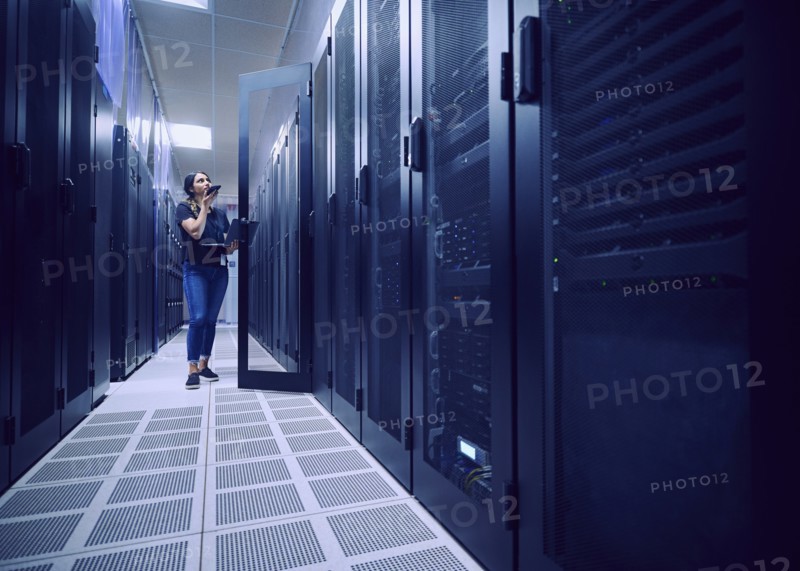 Female technician working in server room