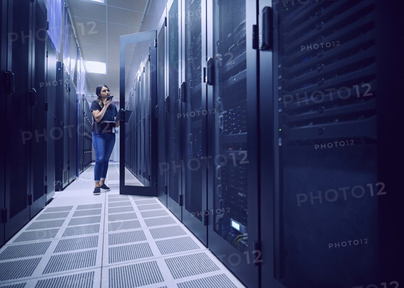 Female technician working in server room