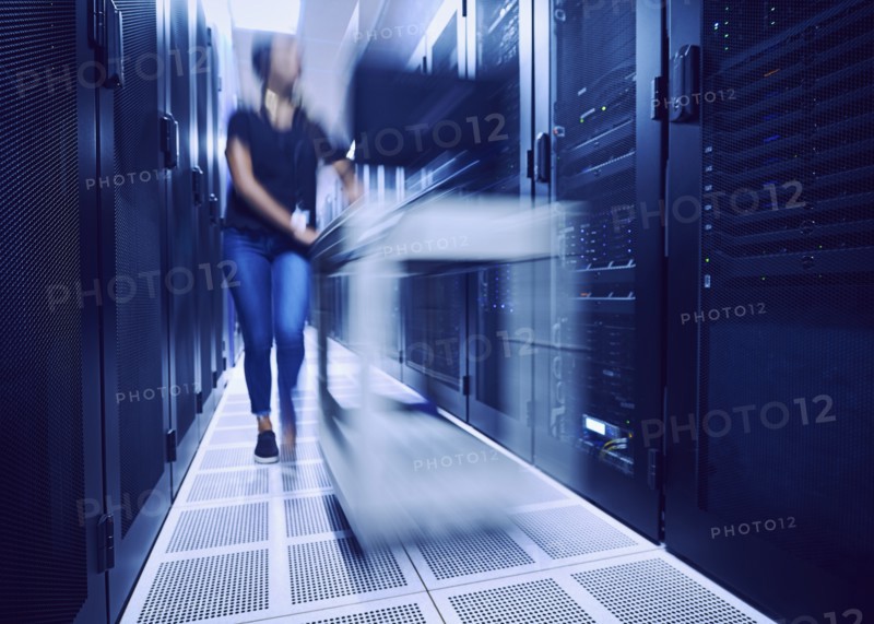 Female technician walking in server room