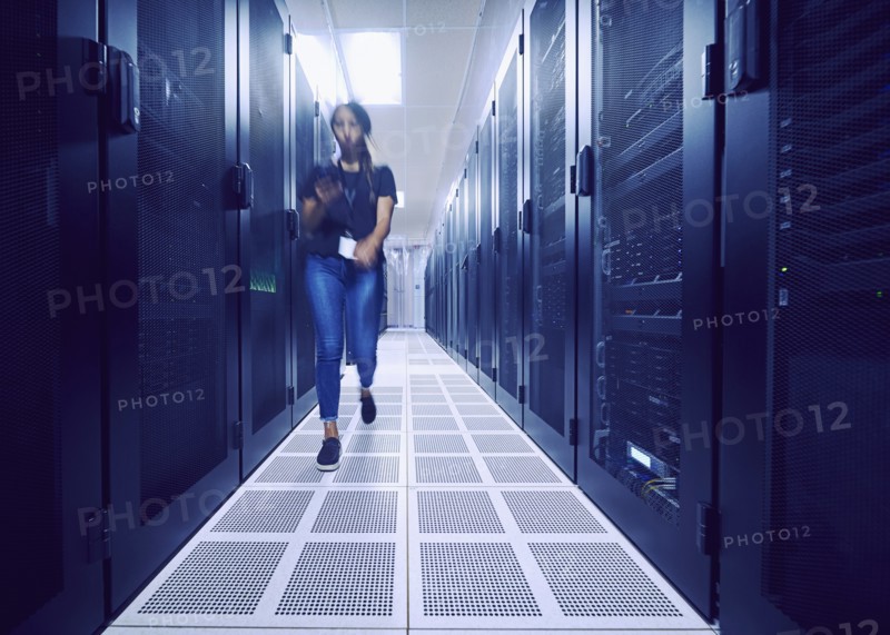 Female technician walking in server room
