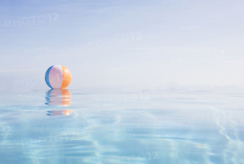Beach ball floating on water surface