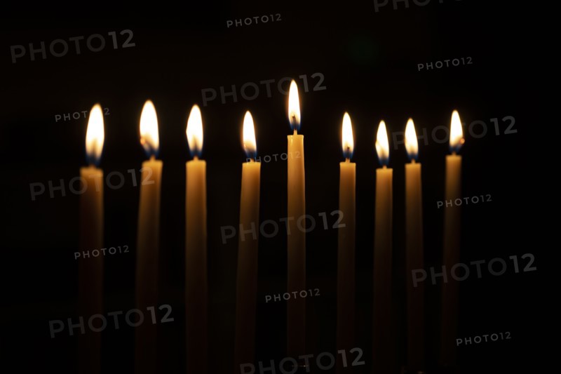Row of candles against black background