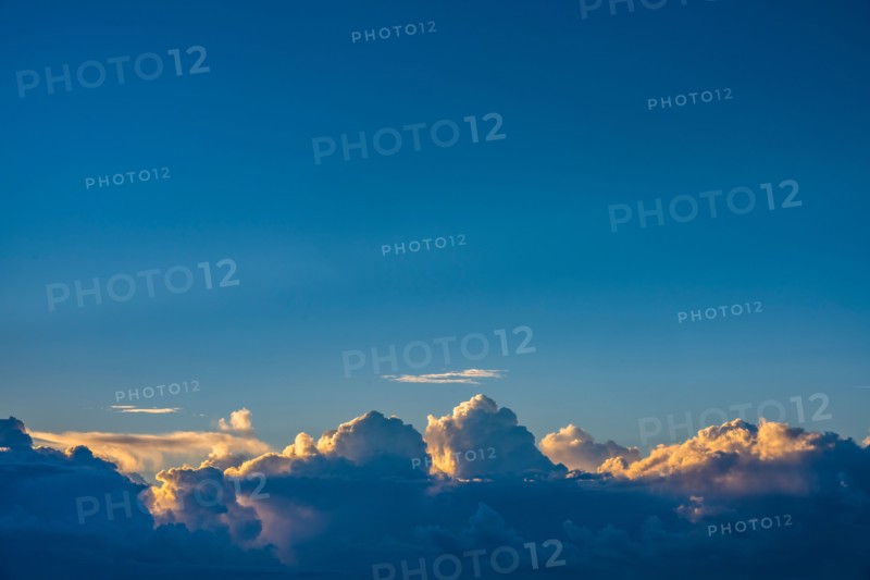Cumulus clouds on blue sky at sunrise