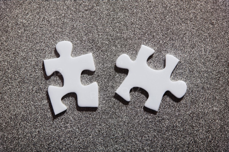 Two white jigsaw pieces