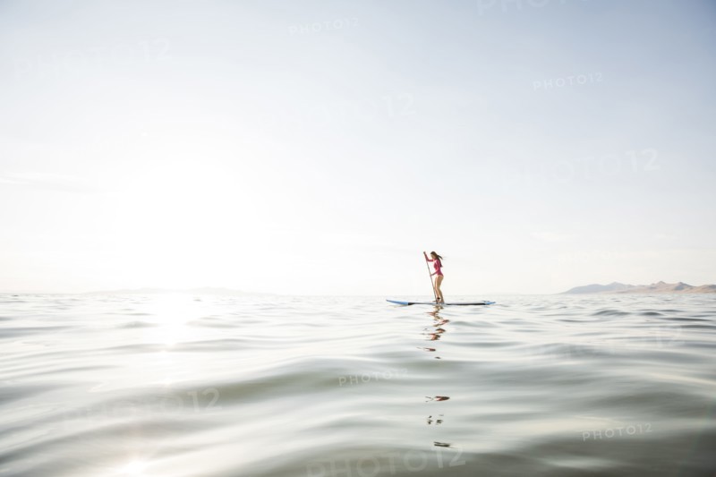 Woman paddleboarding on lake