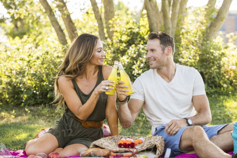 Smiling couple enjoying picnic in park