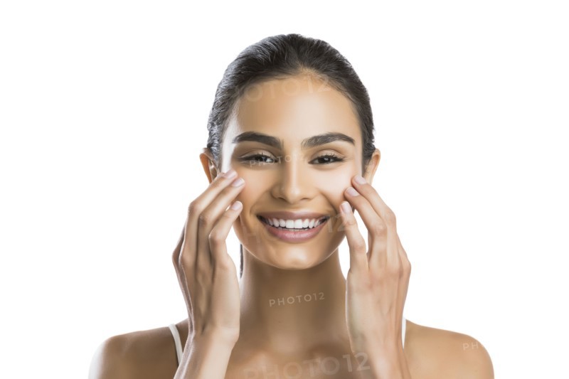 Portrait of young woman doing face massage