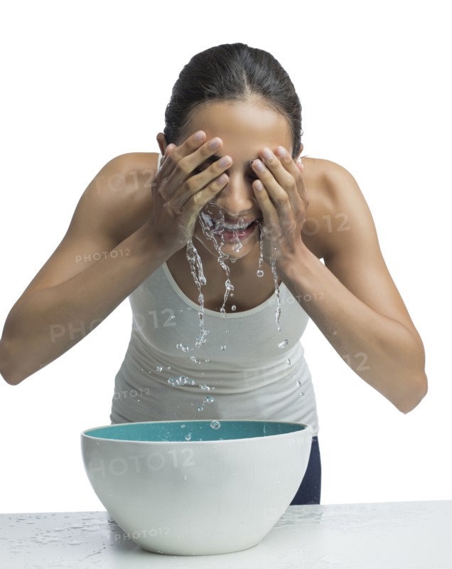 Portrait of young woman washing face