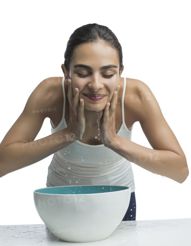 Portrait of young woman washing face