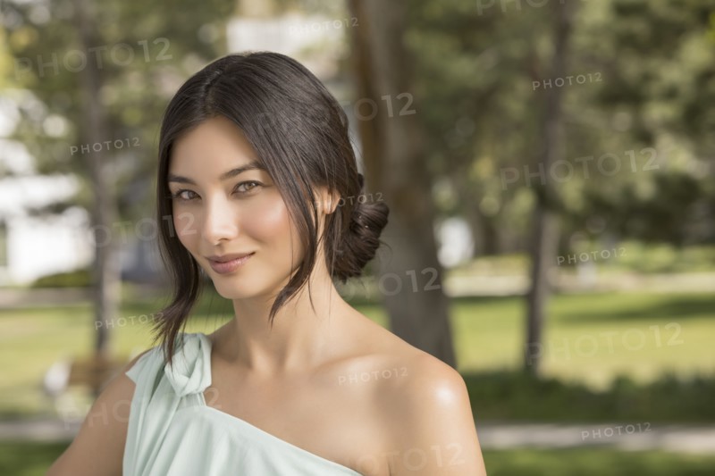 Portrait of beautiful woman looking at camera in park