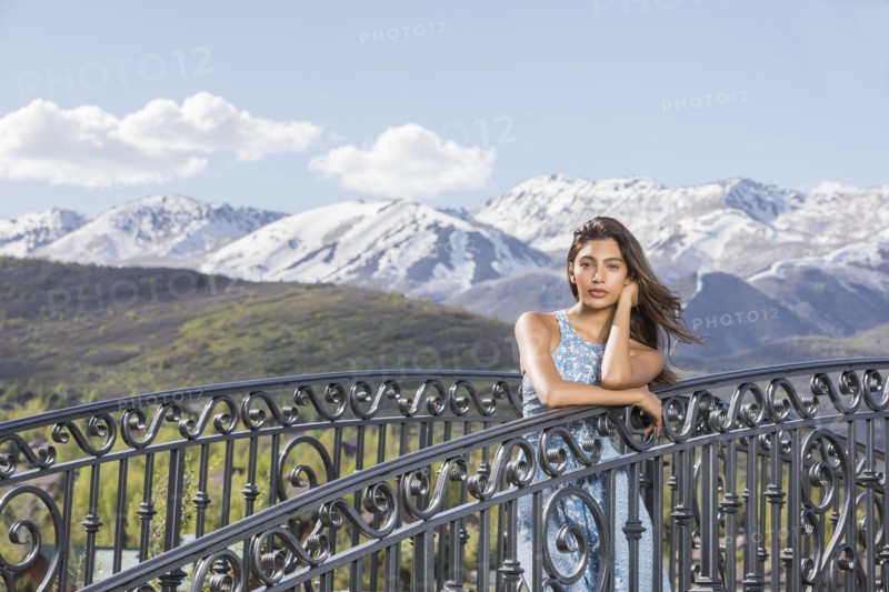 Portrait of beautiful woman on footbridge in mountain scenery