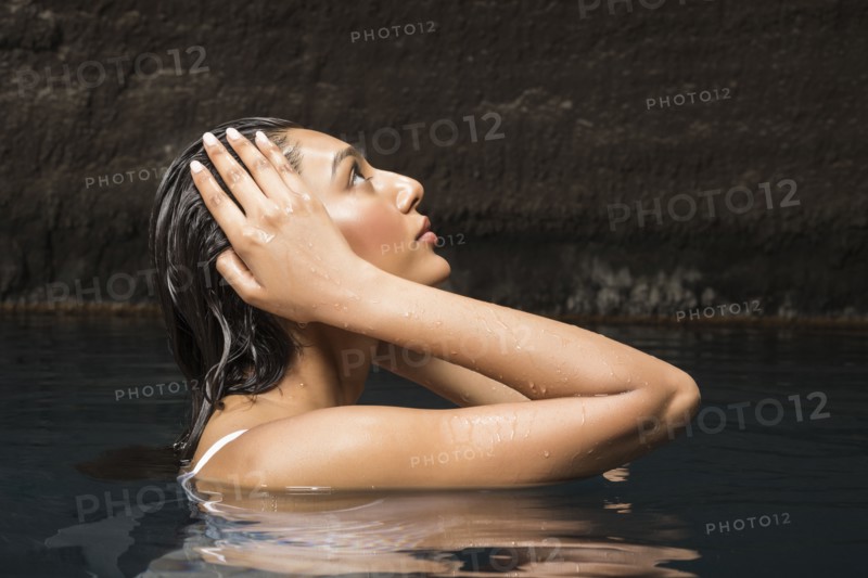 Beautiful woman relaxing in pond