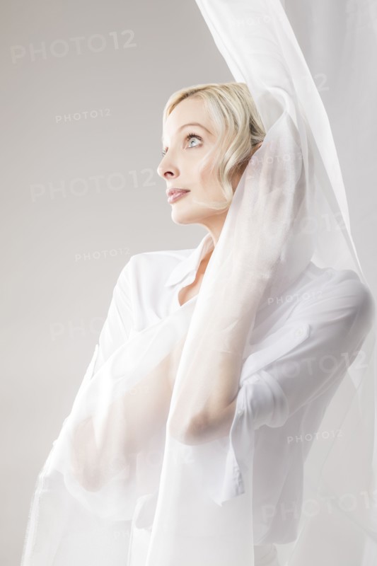 Beautiful woman wrapped in tulle fabric