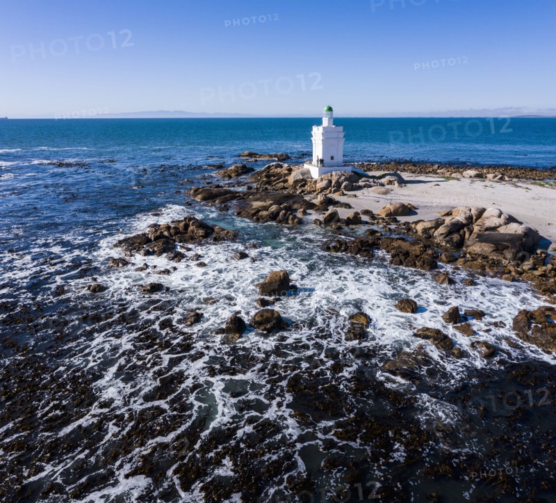 White lighthouse on coast of Atlantic Ocean