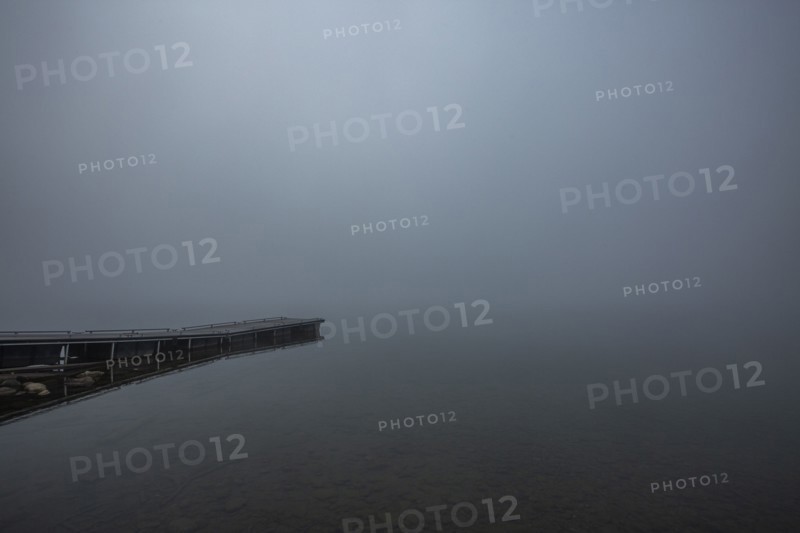 Wooden jetty at edge of mountain lake