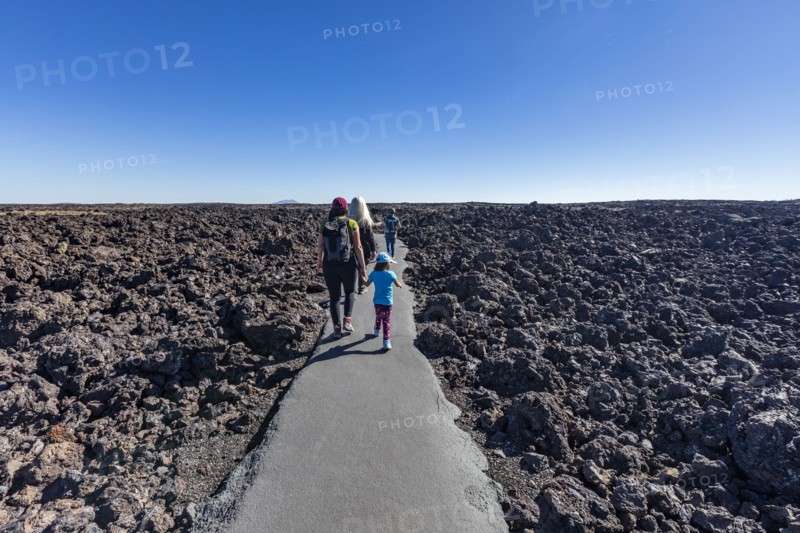 Family walking through lava field