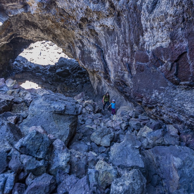 Mother and daughter hiking among rock formations