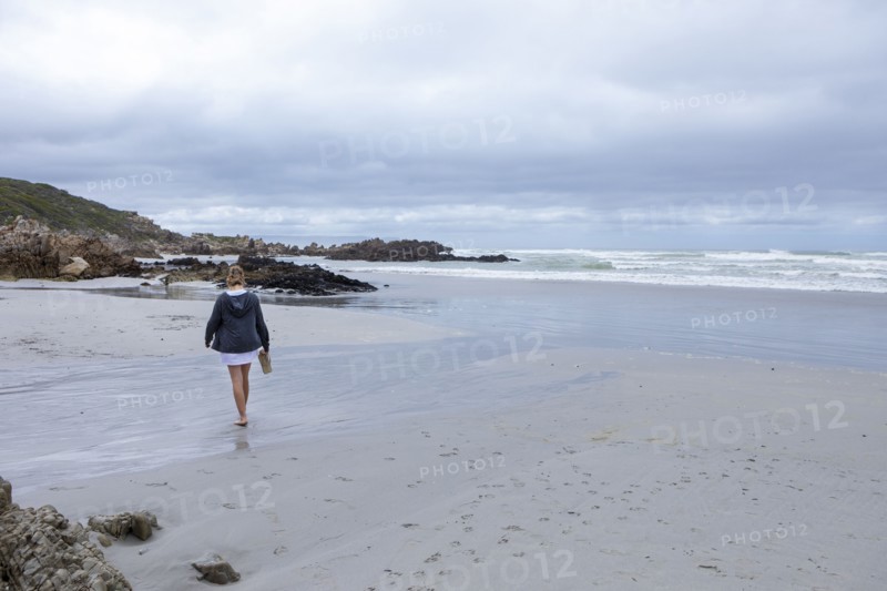 Teenage girl walking on Voelklip beach