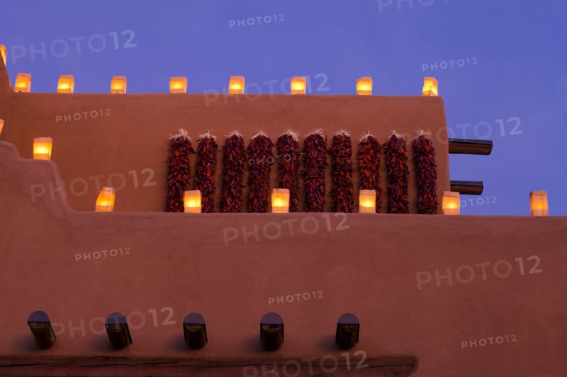 Traditional farolitos lanterns on adobe building