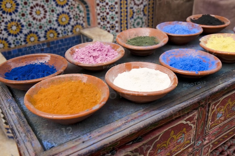 Traditional Moroccan clay bowls of colorful spices