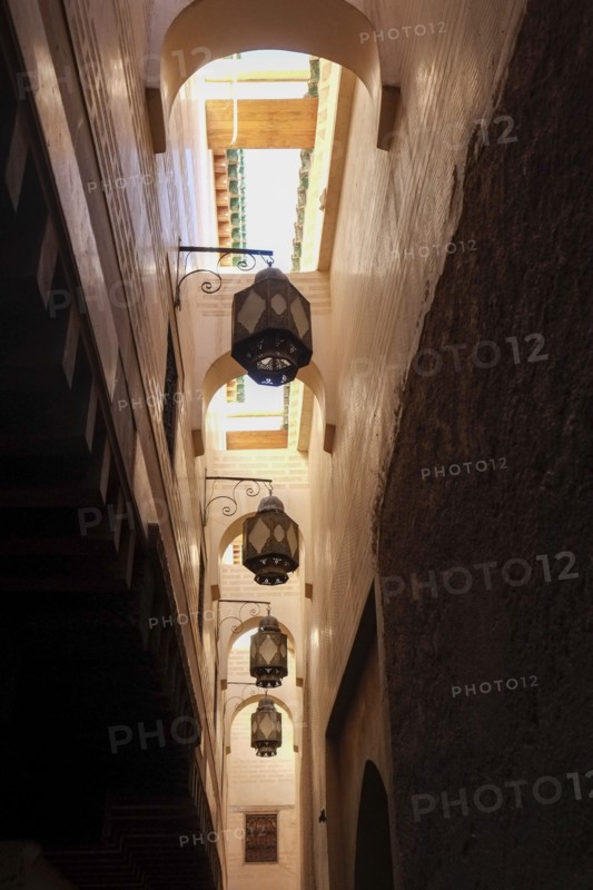 Low angle view of metal streetlamps in alley in medina