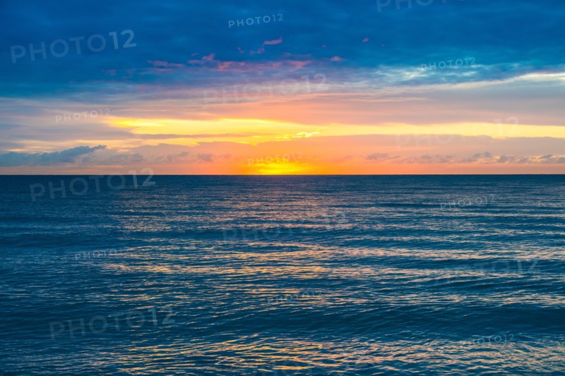 Sunset sky above calm ocean