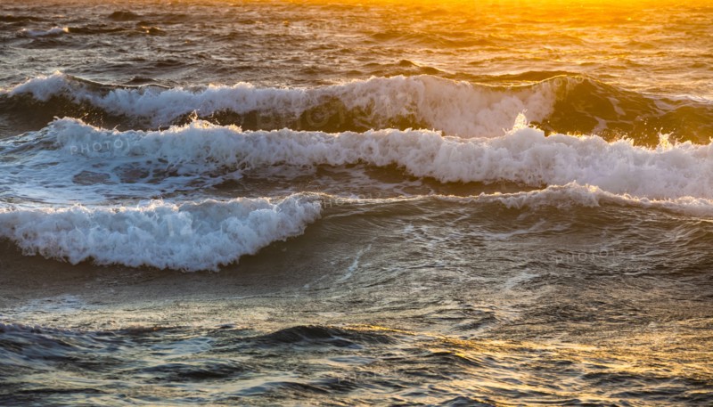 Close-up of sea waves reflecting sunlight