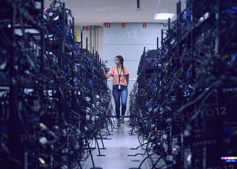 Female technician working in server room